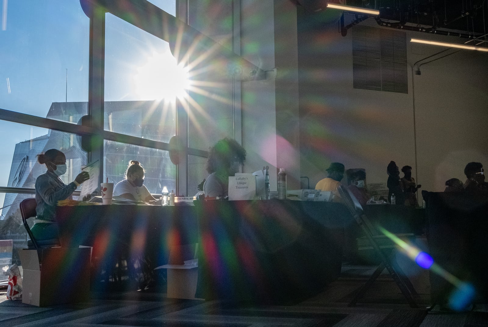 As the sun begins to fall behind Mercedes-Benz Stadium, Fulton County elections workers continue to sort absentee ballots at State Farm Arena on Wednesday afternoon, Nov. 4, 2020. Ben Gray for the Atlanta Journal-Constitution