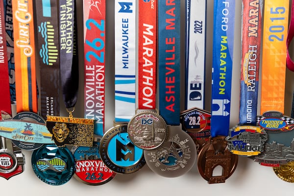 Caroline Burnet’s running medals are seen at her home in Atlanta on Friday, February 28, 2025. Burnet will be running her 200th marathon. (Arvin Temkar / AJC)