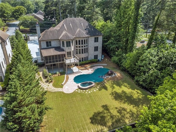 View of the Decatur home’s private backyard and pool with spa.