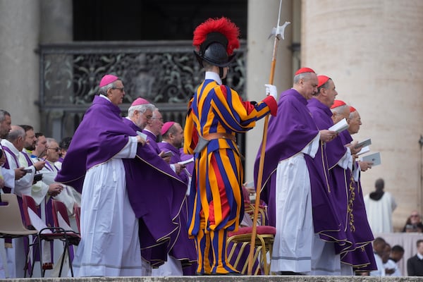 Cardinals and Bishops wearing violet chasubles symbol of Lent, follow Cardinal Michael Czerny, not seen, delegate of Pope Francis who is recovering from pneumonia, celebrating a mass for the members of the world of volunteers in St. Peter's Square at The Vatican, Sunday, March 9, 2025. (AP Photo/Gregorio Borgia)