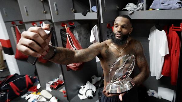  Atlanta Falcons' Justin Hardy takes a selfie with the George Halas Trophy after the NFL football NFC championship game against the Green Bay Packers Sunday, Jan. 22, 2017, in Atlanta. The Falcons won 44-21 to advance to Super Bowl LI. (David J. Phillip/AP)