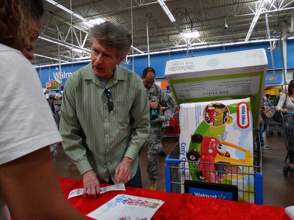 Jeff Darnell has been giving gifts for Clark's Christmas Kids for six years. CREDIT: Rodney Ho/ rho@ajc.com