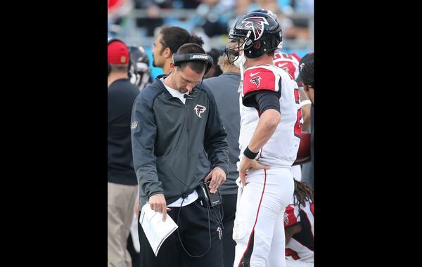 CHARLOTTE: Offensive coordinator Kyle Shanahan paces the sidelines while Matt Ryan, pulled from the game, watches during the fourth quarter as the Panthers beat the Falcons 38-0 in a football game on Sunday, Dec. 13, 2015, in Charlotte. The Falcons were minus-11 in turnover ration while going 1-5 against NFC South foes. (Curtis Compton / ccompton@ajc.com)