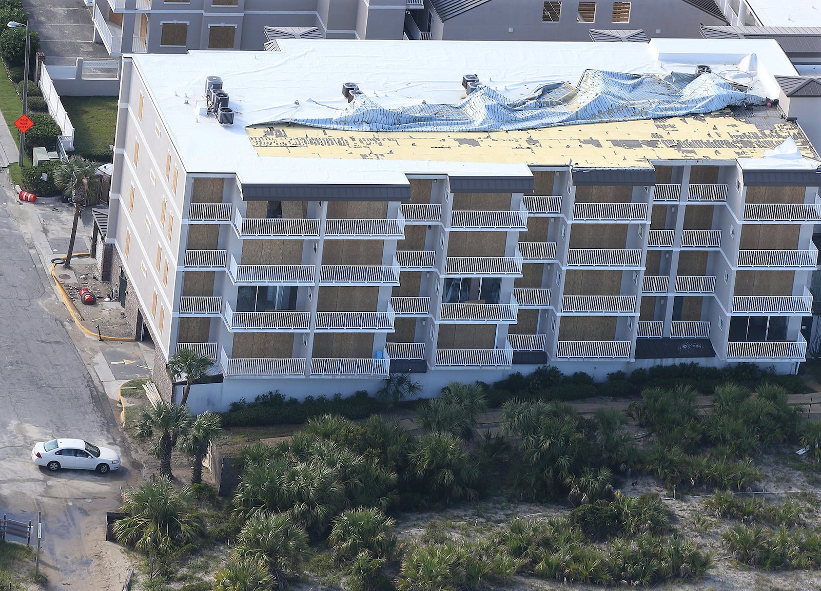 The roof of a boarded up hotel on Tybee Island shows storm damage after Hurricane Irma. Metro Atlanta hotels saw an increase in occupancy following the storm. Curtis Compton/ccompton@ajc.com AJC FILE PHOTO