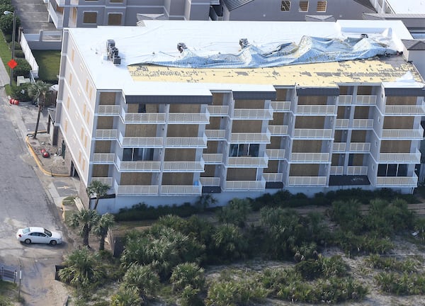 The roof of a boarded up hotel on Tybee Island shows storm damage after Hurricane Irma. Metro Atlanta hotels saw an increase in occupancy following the storm. Curtis Compton/ccompton@ajc.com AJC FILE PHOTO