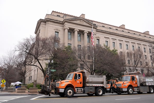 Trucks providing a security barrier are in place around the Department of Justice before President Donald Trump speaks Friday, March 14, 2025, in Washington. (AP Photo/Jacquelyn Martin)