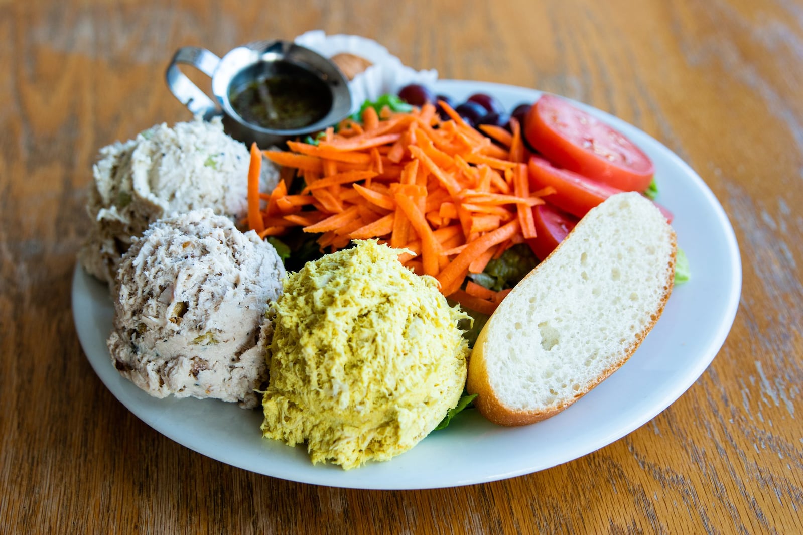 Cafe at Pharr offers chicken salad plates with a baguette slice, red grapes and the restaurant’s famous yogurt rolls. CONTRIBUTED BY HENRI HOLLIS