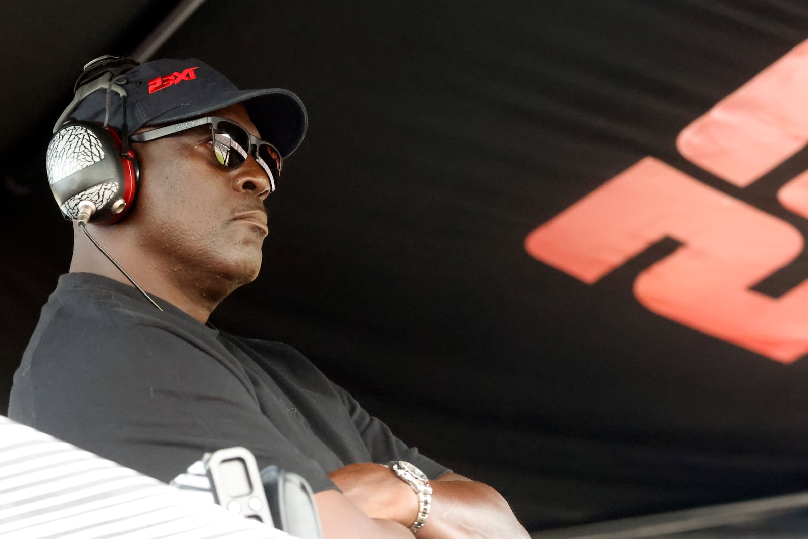 Michael Jordan, co-owner of 23XI Racing, sits in his pit box during a NASCAR Cup Series auto race at Talladega Superspeedway, Sunday, Oct. 6, 2024, in Talladega, Ala. (AP Photo/ Butch Dill)