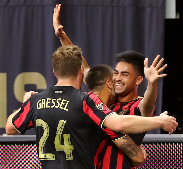 Atlanta United midfielder Pity Martinez (right) celebrates with Hector Villalba (left) and Julian Gressel after scoring his goal against Orlando City for a 1-0 lead Sunday, May 12, 2019, in Atlanta.  