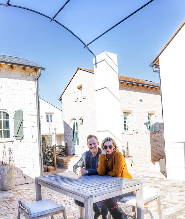 Michael Albanese (left) and actress Wynn Everett, who stars in the movie "Palmer," in front of their "Folklore Cottage" home at The Micro Villages at Trilith. In addition to this micro home, the spouses also own a larger home in the community. Text by Mike Rieman