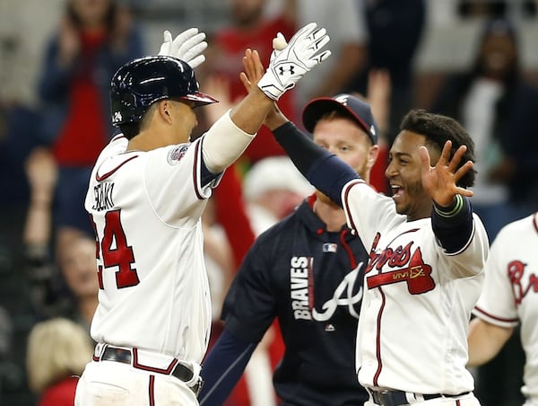  Braves veteran Kurt Suzuki (left) and rookie Ozzie Albies celebrate after Suzuki drove in the winning run on a ninth-inning walk-off hit Thursday. Albies drove in the tying run earlier in the inning. (Getty Images)