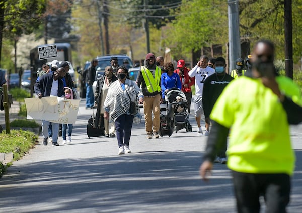 Participants walk along Bolton Road to the site of the former Chattahoochee Brick Company during a sacred event to commemorate the lives lost during a period the company used the convict lease system. The event included a procession, prayers, libations, community testimonials, and site consecration Saturday, April 3, 2021, in Atlanta. (Photo: Daniel Varnado for The Atlanta Journal-Constitution)