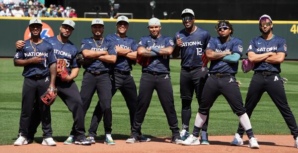 Ozzie Albies (far left), Orlando Arcia (center) and Ronald Acuna Jr. (second from right) pose with their National League teammates prior to the MLB All-Star baseball game in Seattle, Tuesday, July 11, 2023. (AP Photo/Ted S. Warren)