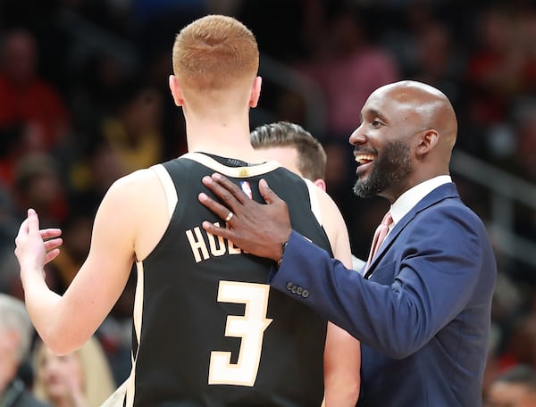 Hawks guard Kevin Huerter gets a pat on the back from coach Lloyd Pierce during a timeout Sunday, Dec. 15, 2019, against the Los Angeles Lakers at State Farm Arena in Atlanta. (Curtis Compton/ccompton@ajc.com)