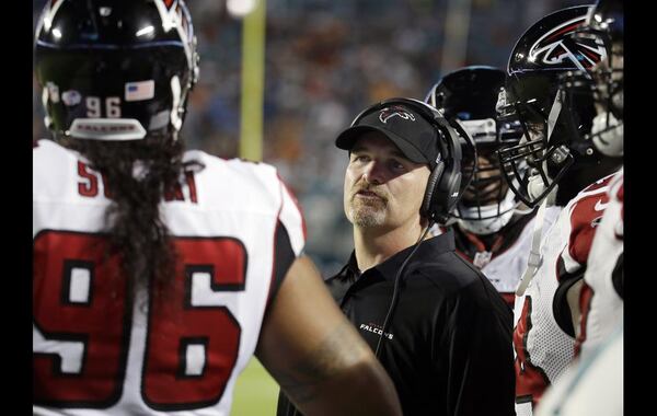 Atlanta Falcons head coach Dan Quinn speaks to Atlanta Falcons defensive tackle Paul Soliai (96) during the first half of a preseason NFL football game, Saturday, Aug. 29, 2015 in Miami Gardens, Fla. (AP Photo/Lynne Sladky)