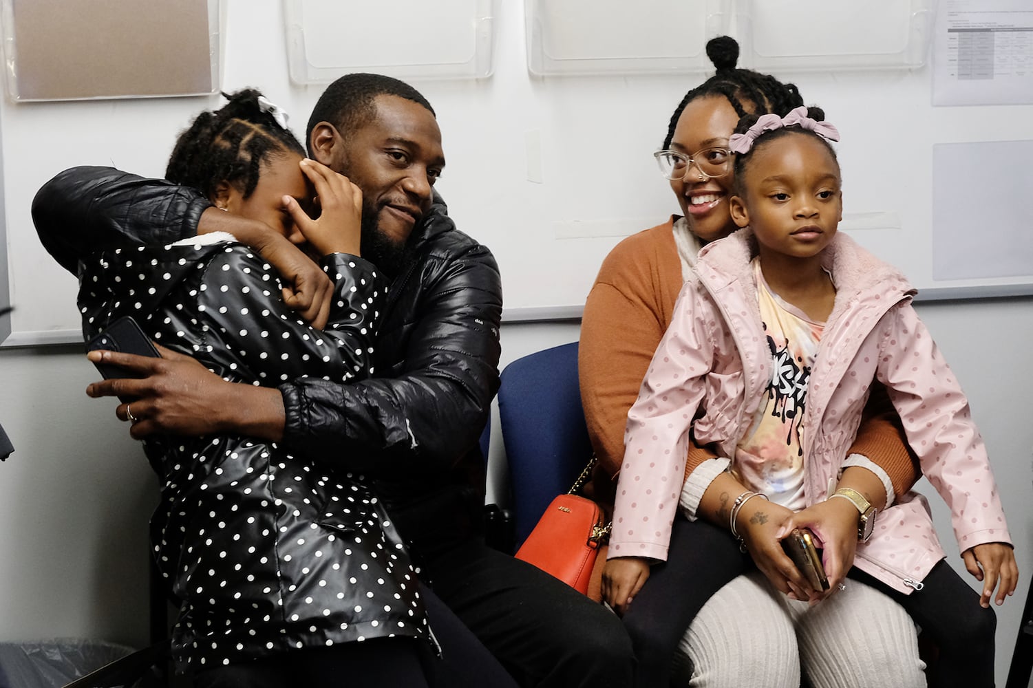 Kendyal Freeman, 8 is hugged by her dad as her family learns they have a gift card to spend at Academy for the holidays. Carson Beck was on site at an Athens Academy store Sunday December 17, 2023, to give out gift cards to lucky members of area Boys and Girls Clubs. Academy contributed $200 for each child and he kicked in $135 more of his own money to help families out. 

credit: Nell Carroll for the AJC