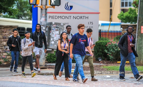 Students return to Georgia State University in downtown Atlanta Monday morning hours after university police officers exchanged gunfire with a man near a housing complex. JOHN SPINK / JSPINK@AJC.COM