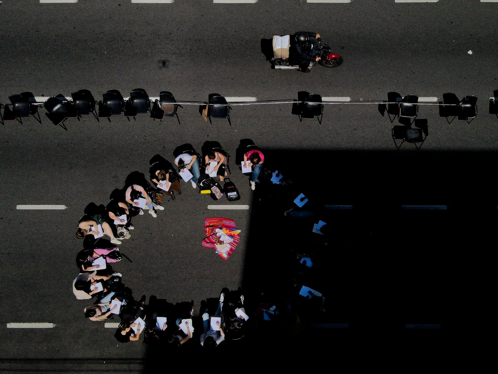 Students hold class in the middle of a street outside the Faculty of Psychology to protest President Javier Milei's veto of higher funding for public universities, in Buenos Aires, Argentina, Wednesday, Oct. 16, 2024. (AP Photo/Natacha Pisarenko)