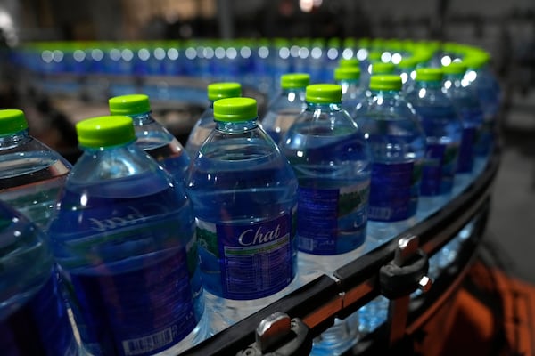 Completed plastic bottles of the Chat Cola Company brand Chat drinking water move along a production line in the Palestinian company's bottling plant, in the West Bank city of Salfit, Feb. 13, 2025. (AP Photo/Nasser Nasser)