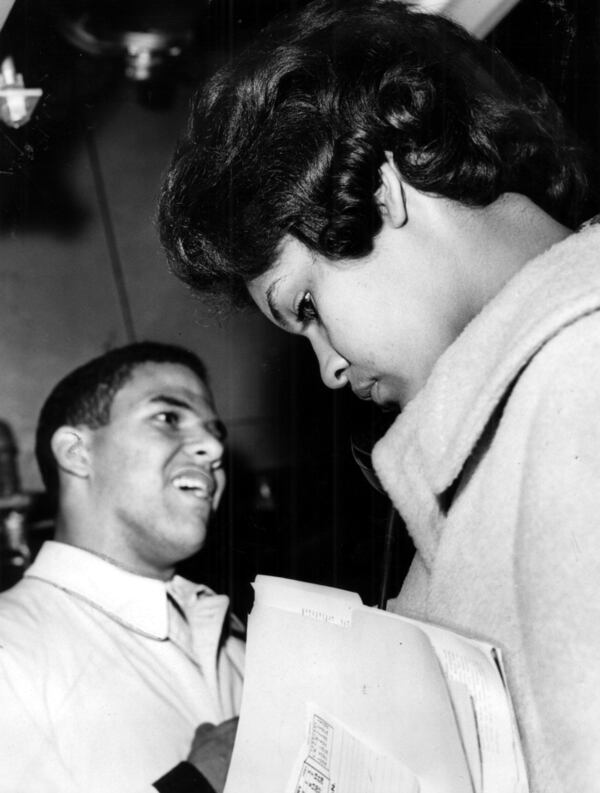 Jan. 9, 1961 - ATHENS, GA -- Charlayne Hunter makes a phone call on the University of Georgia campus as Hamilton Holmes waits for her on Jan. 9, 1961. 
MANDATORY CREDIT: CHARLES PUGH / THE ATLANTA JOURNAL-CONSTITUTION