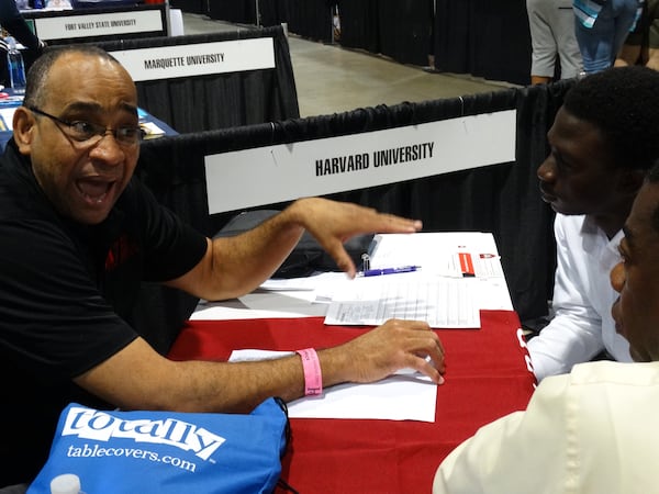 Mark Lewis, a Harvard Kennedy School of Government graduate, gives advice at the college expo portion to Mase Fasetire, who wants to transfer from Georgia Southern to Harvard, CREDIT: Rodney Ho/ rho@ajc.com