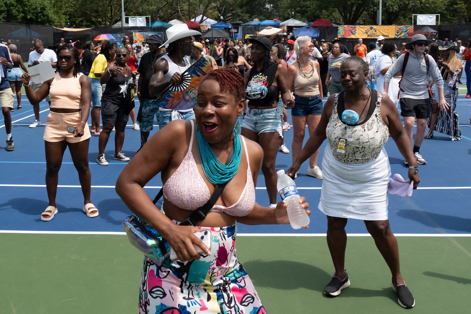 People dance on the tennis courts at Grant Park during the 20th anniversary of the House In The Park music festival in Atlanta on Sunday, Sept. 1, 2024. (Ben Gray / Ben@BenGray.com)