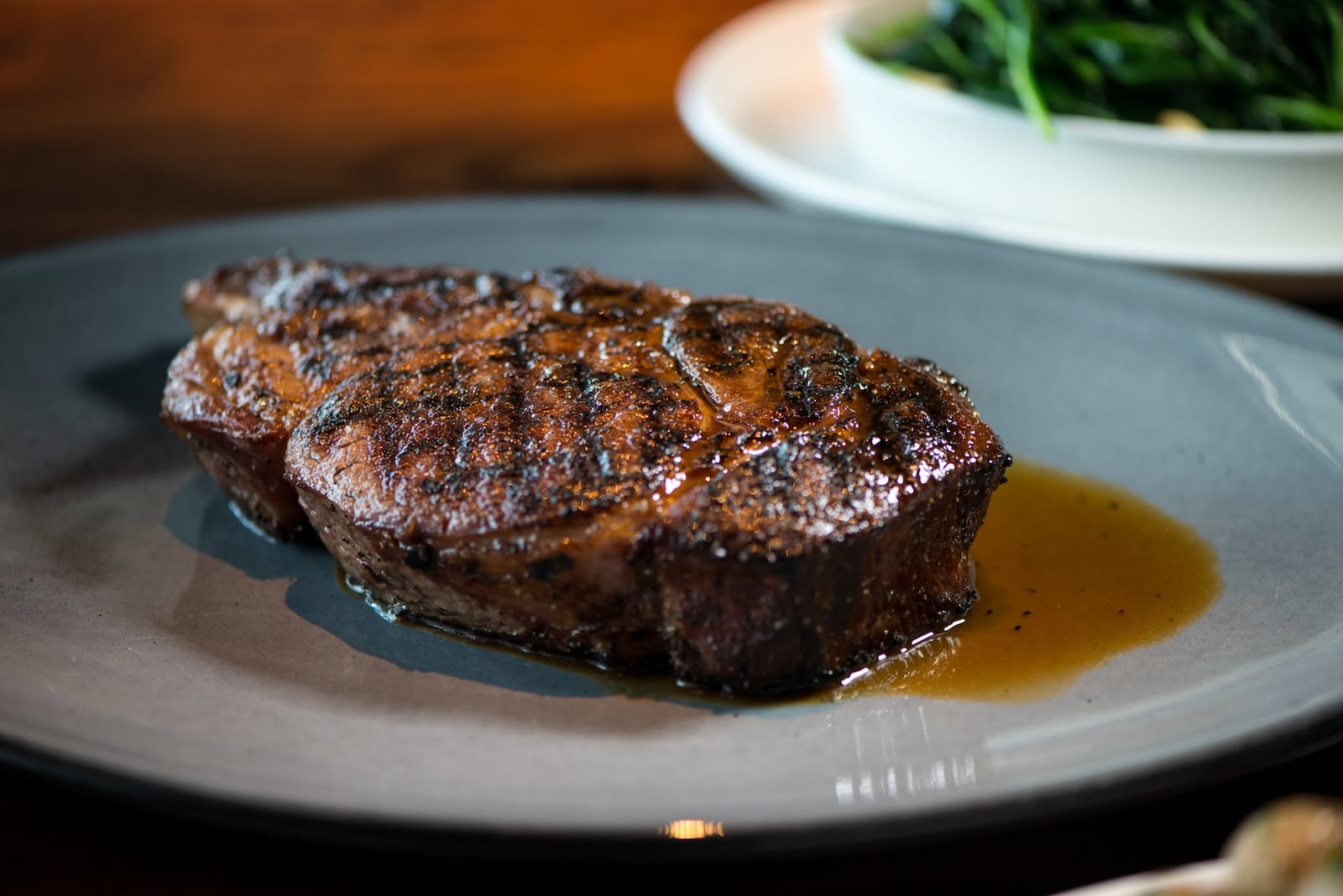 Kaiser’s Chophouse Prime Cowboy Ribeye is 20-ounces of dry-aged, bone-in steak. Photo credit- Mia Yakel.