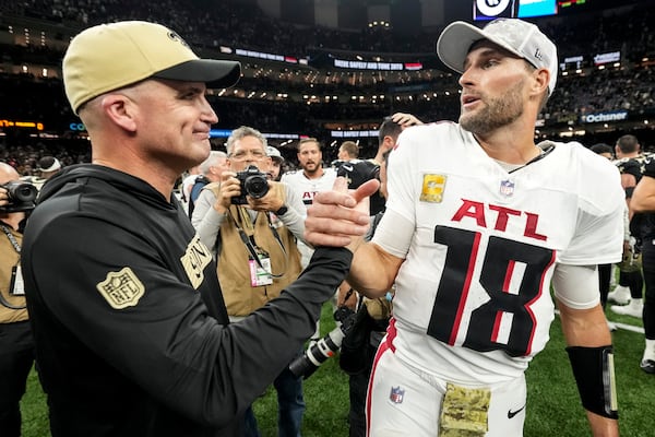 New Orleans Saints interim head coach Darren Rizzi spwaks with Atlanta Falcons quarterback Kirk Cousins (18) after an NFL football game, Sunday, Nov. 10, 2024, in New Orleans. The New Orleans Saints won 20-17. (AP Photo/Gerald Herbert)