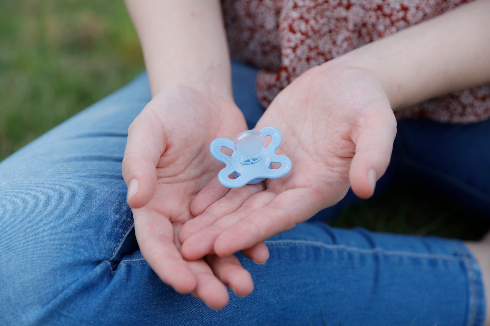 A  21-year-old Columbus area woman holds her newborn’s  pacifier on Wednesday, June 7, 2023. After an unexpected pregnancy last year, she planned on getting an abortion but changed her mind and is now married with a  one month old son.  (Natrice Miller/natrice.miller@ajc.com)