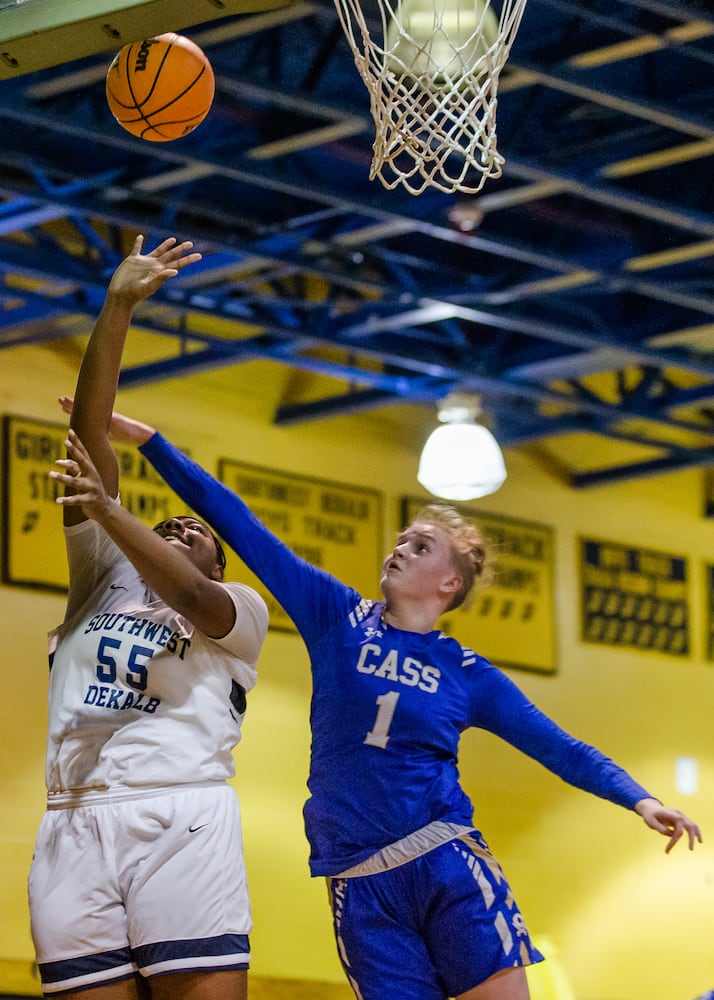 Claire Davis (right), center for Cass High School, blocks a layoff attempt by Adrieanna Browniee (left), center for South Dekalb High School,  during the South Dekalb vs. Cass girls basketball playoff game on Friday, February 26, 2021, at South Dekalb High School in Decatur, Georgia. South Dekalb defeated Cass 72-46. CHRISTINA MATACOTTA FOR THE ATLANTA JOURNAL-CONSTITUTION