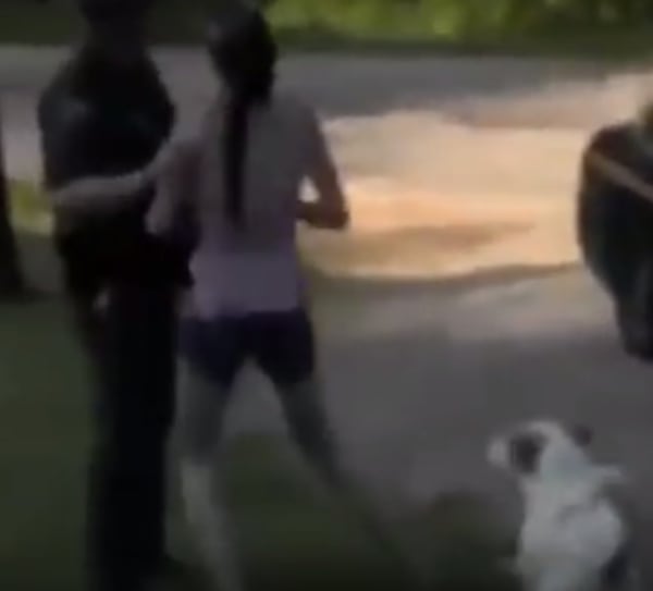 Tiffanie Hupp stands between a West Virginia State Trooper and Buddy, her father-in-law's dog. (Image from YouTube video)