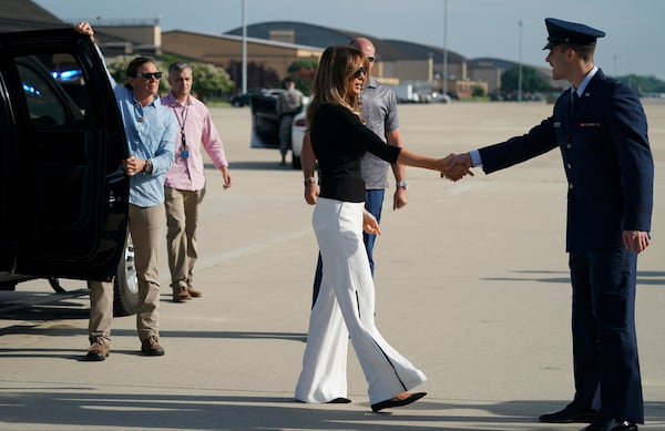 First lady Melania Trump is greeted as she boards an airplane at Andrews Air Force Base, Md., Thursday, June 28, 2018. The first lady is traveling to Arizona view additional immigration facilities.