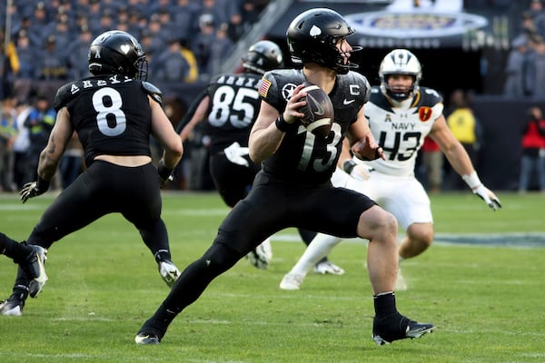 Army quarterback Bryson Daily (13) sets to throw a pass during the first half of an NCAA college football game against Navy, Saturday, Dec. 14, 2024, in Landover, Md. (AP Photo/Daniel Kucin Jr.)