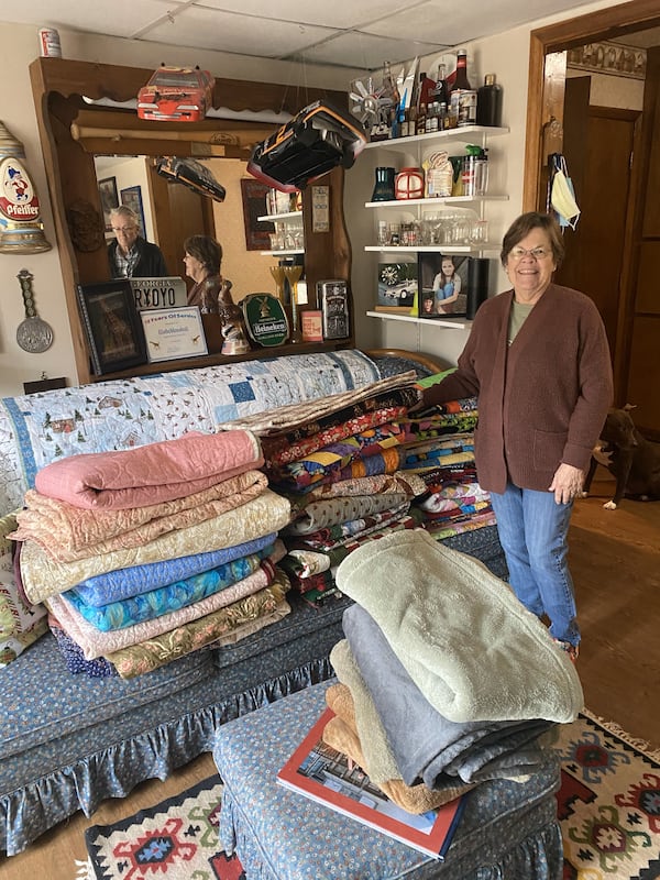 Elleda Rule, a  member of the Nesty sewing circle, shows off some of the quilts created by her group. Photo: Jenni Girtman