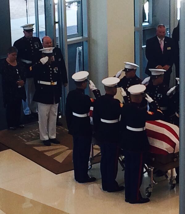 Marines salute Lance Cpl. Skip Wells' flag-draped coffin. Photo: Jennifer Brett