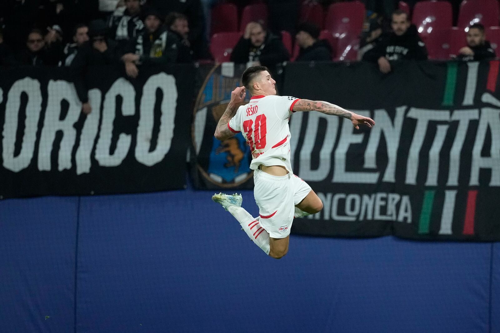 Leipzig's Benjamin Sesko celebrates after he scored during the UEFA Champions League opening phase soccer match between Leipzig and Juventus in Leipzig, Germany, Wednesday, Oct. 2, 2024.(AP Photo/Ebrahim Noroozi)