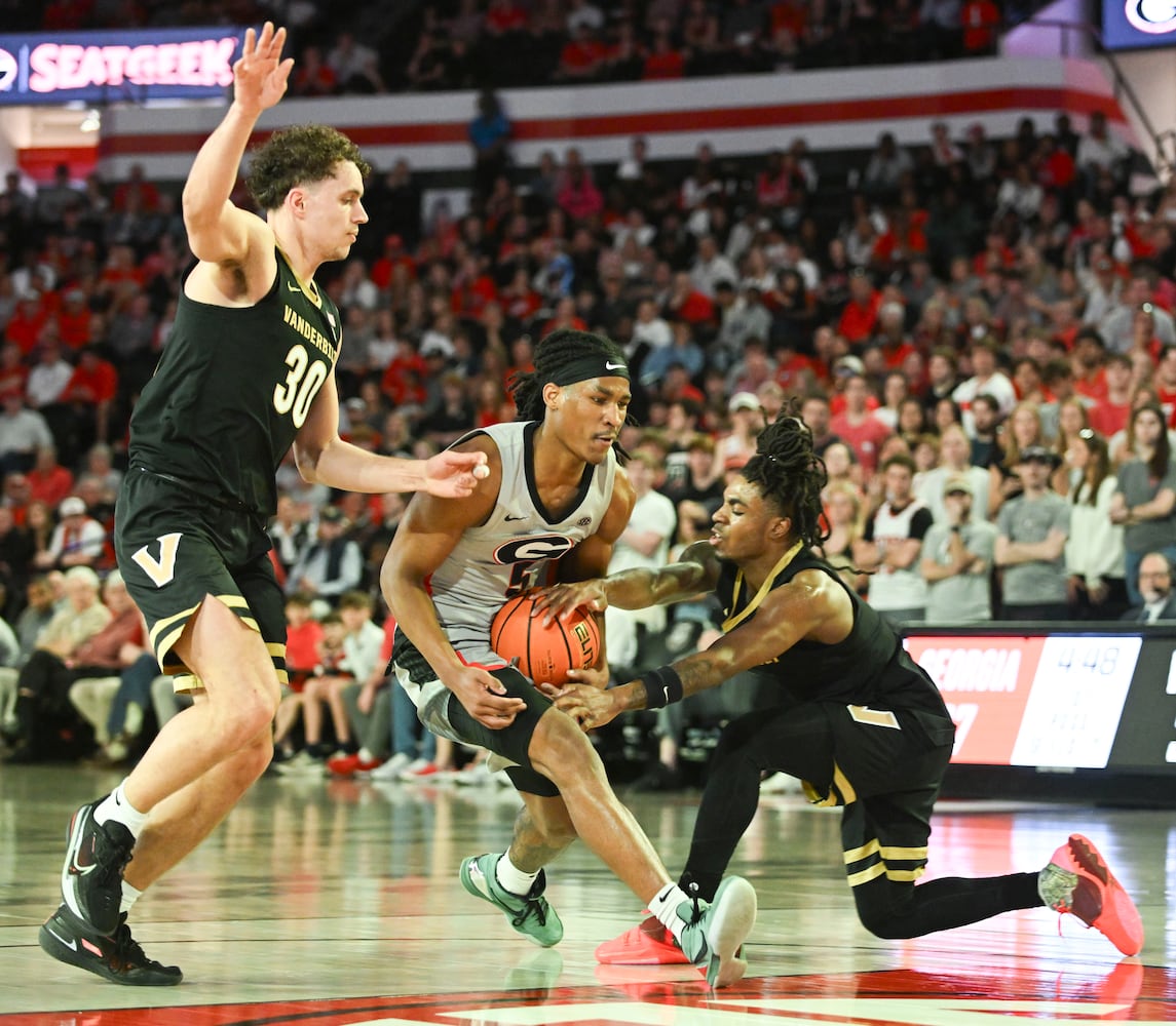 Vanderbilt guards AJ Hoggard (11) and Chris Manon (30) put pressure on Georgia guard Silas Demary Jr. (5) as he drives to the basket during the first half of an NCAA Basketball game Saturday, March 8, 2025 at Stegeman Coliseum in Athens. (Daniel Varnado/For the Atlanta Journal-Constitution)