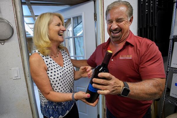 Kathy Loder, left, and her husband, Ron Loder, with a bottle of their wine at their home winery in Granite Bay, Calif., on July 26, 2017. (Randall Benton/Sacramento Bee/TNS)