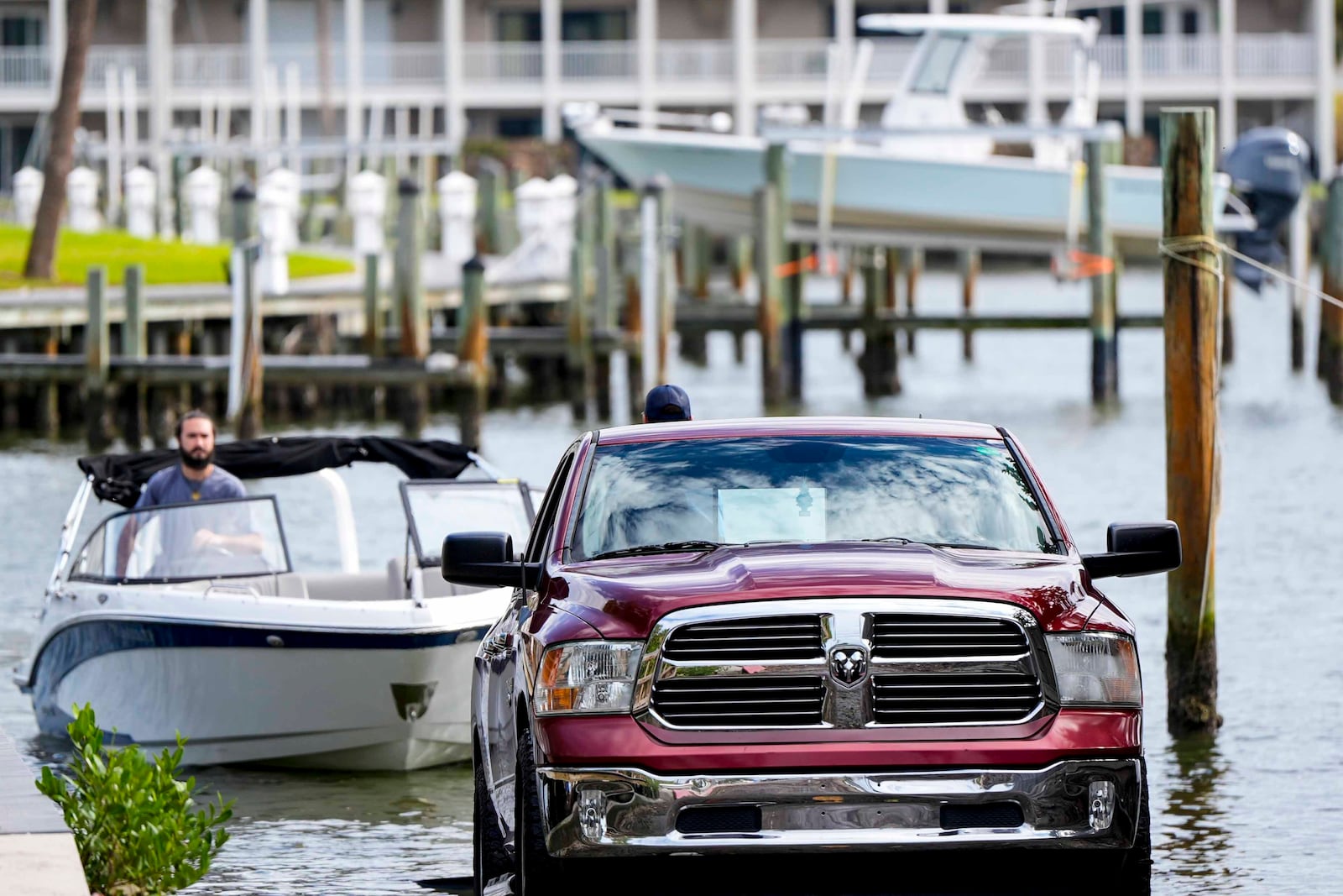 People move their boats ahead of Hurricane Milton, Tuesday, Oct. 8, 2024, in Treasure Island, Fla. (AP Photo/Mike Stewart)