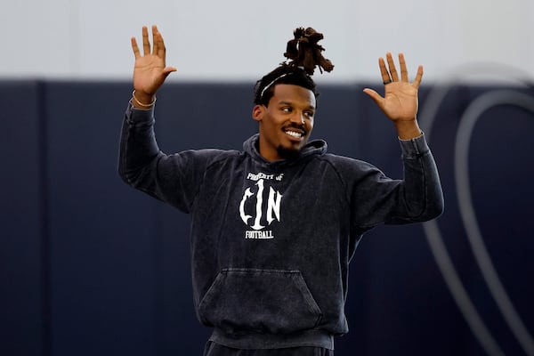 Former NFL and Auburn quarterback, Cam Newton, warms up during Auburn Pro Day, Tuesday, March 21, 2023, in Auburn, Ala. (AP Photo/Butch Dill)