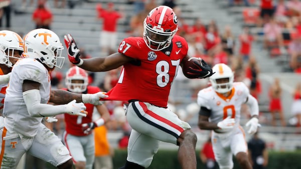 Georgia tight end Tre McKitty (87) gets some distance from a Tennessee defender for extra yardage Saturday, Oct. 10, 2020, at Sanford Stadium in Athens. (Andrew Davis Tucker/UGA Sports)