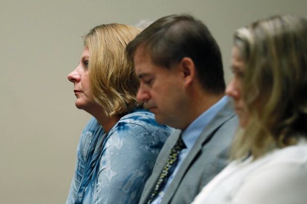 September 27, 2019 - Decatur - Kathy Olsen (left), wife of Robert Olsen, sits with family members during testimony this morning.  The murder trial of former DeKalb County Police Officer Robert "Chip" Olsen continued with testimony from prosecution witnesses this morning.  Olsen is charged with murdering war veteran Anthony Hill.  Bob Andres / robert.andres@ajc.com