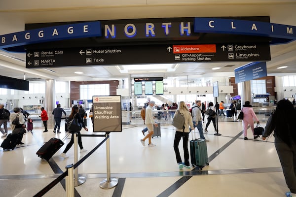 Passengers walk through the North Terminal as they leave the Hartsfield-Jackson Atlanta International Airport on Thursday, October 27, 2022. This coming holiday season, Airport crowds are expected as Thanksgiving travel rebounds. Miguel Martinez / miguel.martinezjimenez@ajc.com