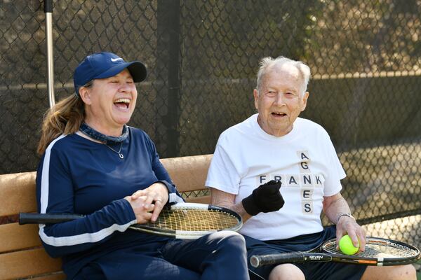 Frank Stovall couldn't find his tennis glove one day, so he put on a gardening glove. It worked just fine, so he kept using it. Here, he meets with Jane Waterman Moss to play some tennis on his 100th birthday. (Hyosub Shin / Hyosub.Shin@ajc.com)