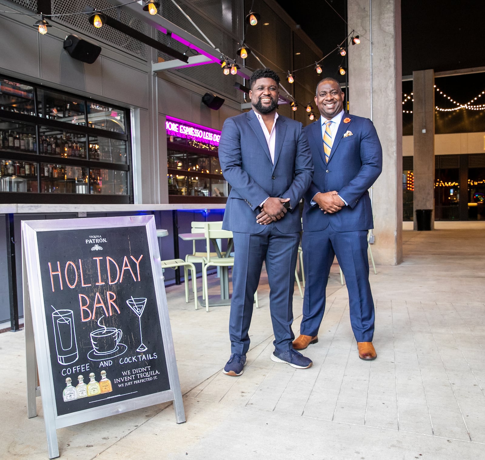 Investor Armond Davis, right, managing partner of The Paragon Group, and "A Seat at The Table Capital" owner Camaran Burke, left, catch up at Holiday Bar in West Midtown, one of Burke's four bars in Atlanta, on Wednesday, March 9, 2022.  Davis is an investor working with black-owned businesses to fill the gap many African Americans face when seeking financing.    Holiday Bar at Howell Mill and 14th offers coffee, cocktails and great patio space.  (Jenni Girtman for The Atlanta Journal-Constitution)