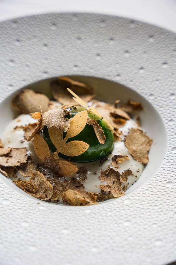 One dish you might encounter at Atlas is a hen's egg coated in an herbaceous green gel and scattered with truffles. Courtesy of Atlas