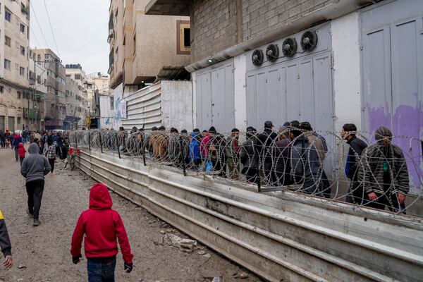 Palestinians queue to purchase bread outside a bakery in Gaza City, Monday, Feb. 24, 2025. (AP Photo/Abdel Kareem Hana)