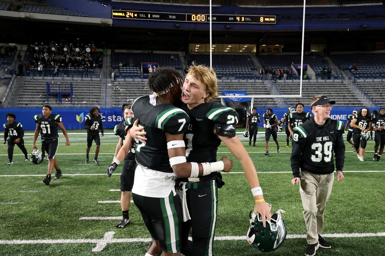 Collins Hill defensive back Jayden Davis (7) and quarterback Sam Horn (21) celebrate their 24-8 win against Milton in the Class 7A state title football game at Georgia State Center Parc Stadium Saturday, December 11, 2021, Atlanta. JASON GETZ FOR THE ATLANTA JOURNAL-CONSTITUTION