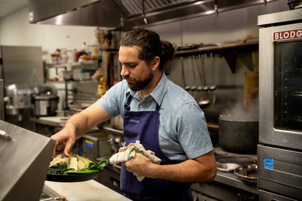 Chef and owner Shay Lavi is at the center of things at Nur Kitchen. (Mia Yakel for The Atlanta Journal-Constitution)