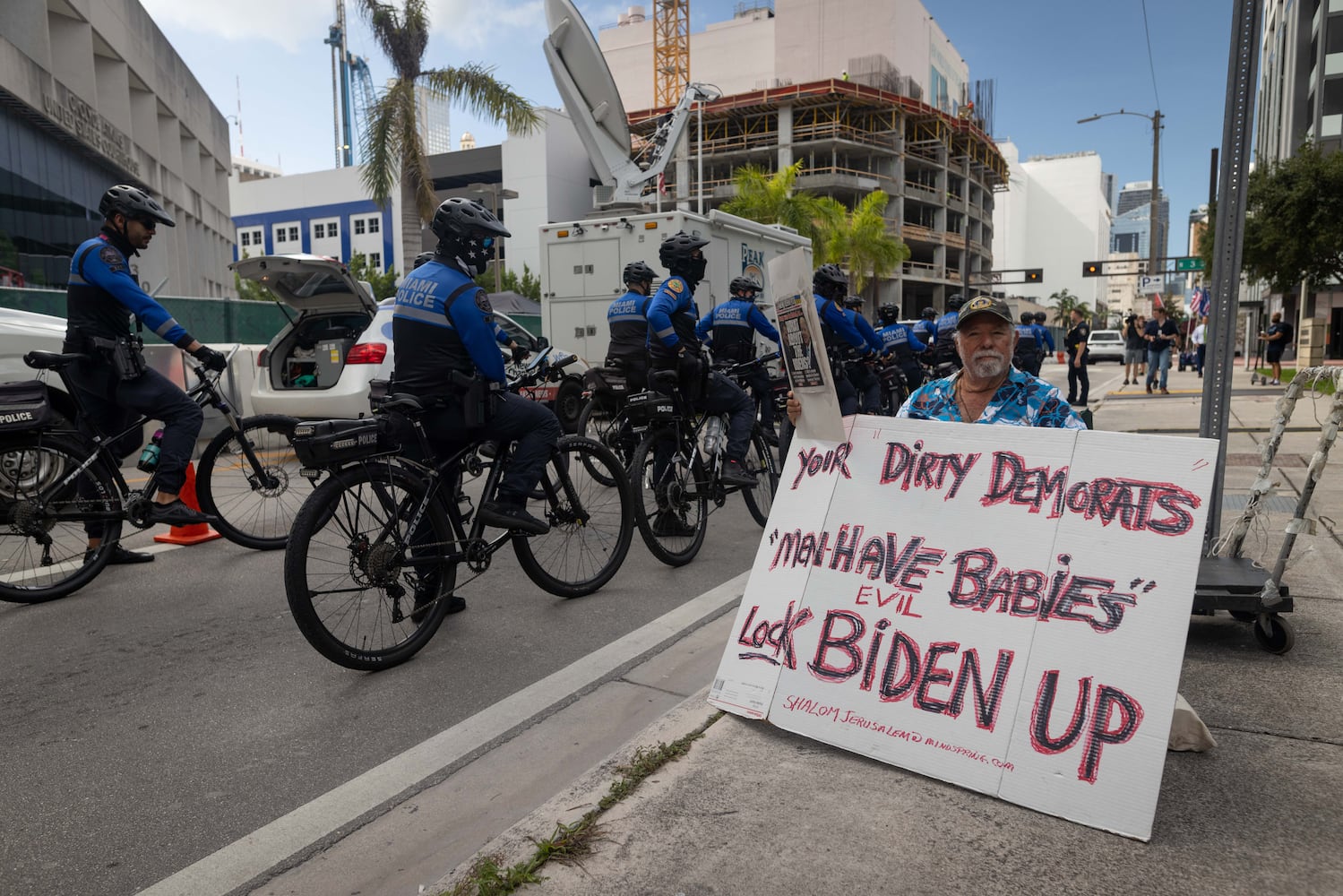 Miami Police on bicycles pass a demonstrator near the Wilkie D. Ferguson Jr. U.S. Courthouse in Miami on Tuesday morning, June 13, 2023.. (Christian Monterrosa/The New York Times)